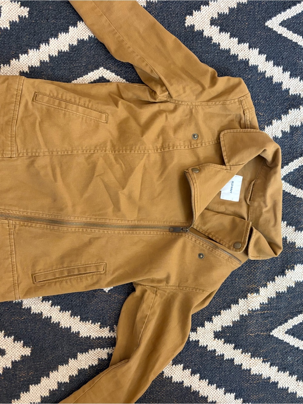 Old Navy White Label with Blue Logo on Tan Fabric